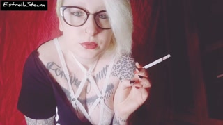 Blonde smokes a cigarette while staring at you