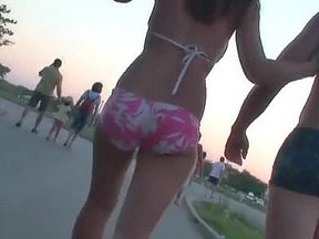 Beach voyeur spying on a woman walking around in her tight bikini