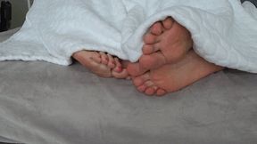 Intertwining toes under the blanket A c