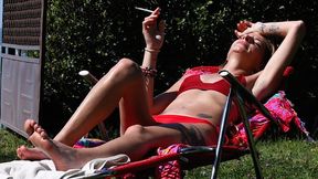 Eve sensually smoking 120's cigarette while sunbathing in slow motion 2