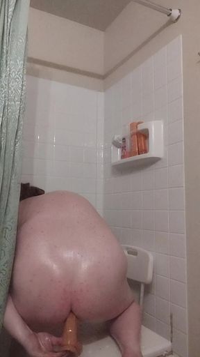 Shower slut takes dildo deep in ass
