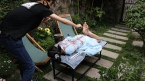 GG46 - In a beautiful garden, a barefoot girl with pigtails is bound and being tickled.