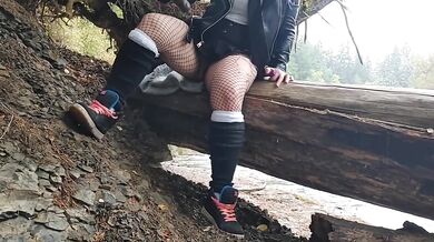 Milf fucks herself with huge dildo beside public river