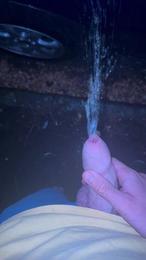 Peeing on a car at night