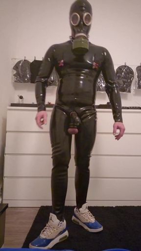 Rubber Gimp jerks himself off with ballstretchers