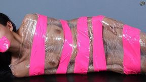 Wrapped In Pink Tape And Plastic, Heather Vahn Is A Tasty Dish Spread Out On The Dining Table