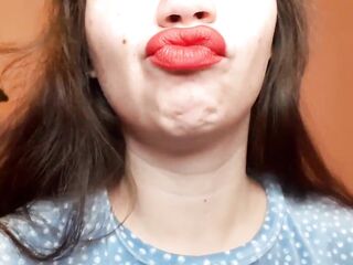 Natural lips with red lipstick smokin' a cigarette in close up