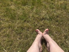 Bare Feet walking in grass - pink painted toe nails