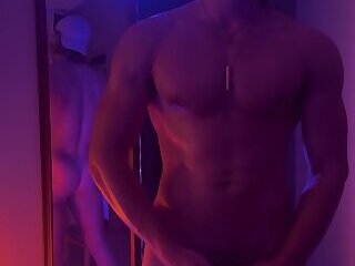 jerk off in front of mirror in moodily lit room