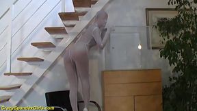 Spandex girl squeezes herself in a glass box