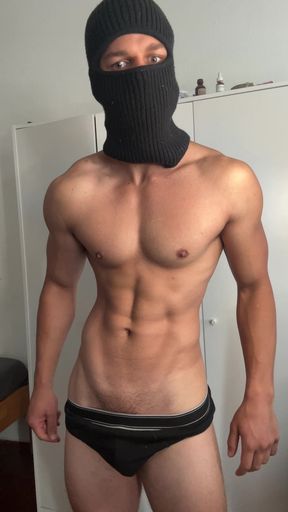 Masked young hunk showing off his muscles