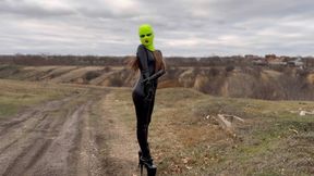 Walk in the forest in a catsuit, high heels, mask