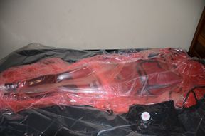 Mar 2 2023 - VacPacked in my long red raincoat under my PVC aprons and pink PVC sack