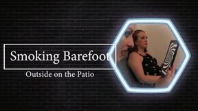 Eve smoking barefoot on the Patio