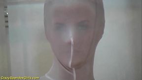 spandex girl squeezes herself in a glass box