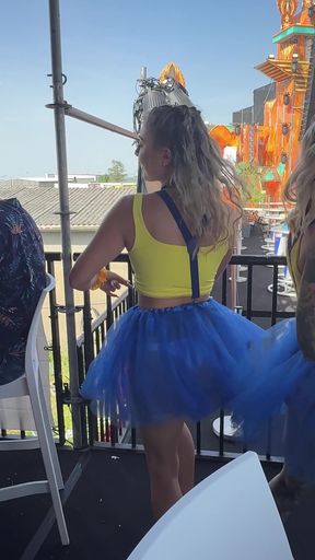 Blonde woman in blue tutu at outdoor event