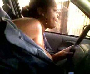 Ebony MILF wife drives car topless exposing her huge tits