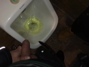Boys piss and spit together at the urinal after some cocktails
