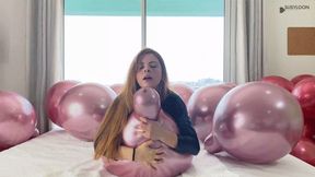 Catsuit girl siting on metal balloons