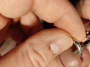 putting on my modified cage so it uses my prince albert piercing