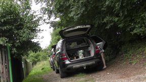 Hot redhead in short skirt loads a car