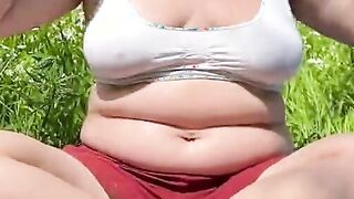 FLASHING GIGANTIC NATURAL TITTED PUBLIC INSIDE A PARK.