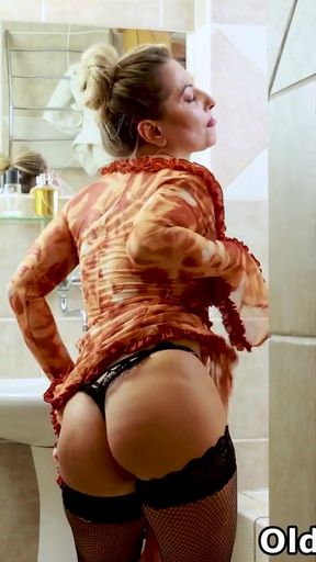 Euro milf Jane Sweet wears black fishnet stockings and relaxes in the bathroom   Clip 1