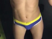 Flexing and showing off in swim trunks