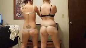 Two juicy babes compare asses in front of a cam