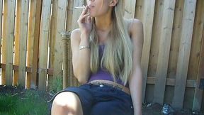 Straight haired cute fresh blondie was smoking a cigarette on her cam