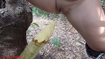 Perverted slut squirts piss from wooden stake in forest