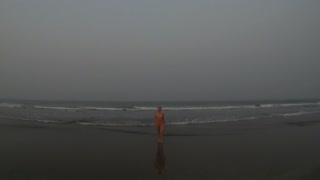 Nude girl on the ocean beach