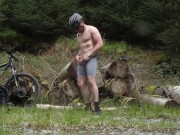 Muscle stud gets naked on a bike ride in the woods, flexes muscles and cums (old vid)