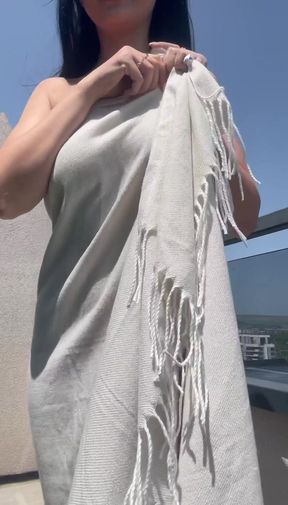 Blonde woman in white dress holding fringe shawl