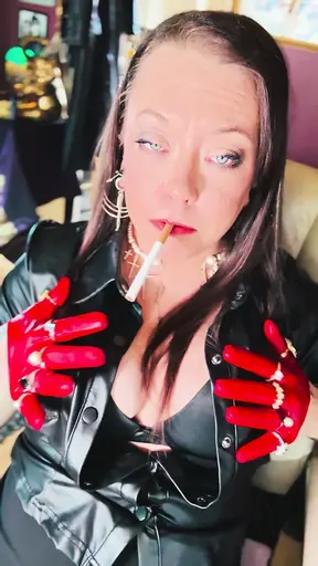 British MILF Tina Snua smokes a cigarette in her short leather gloves and rings.
