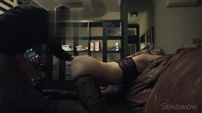 A guy fucks a girl in black pantyhose on a leather sofa at night